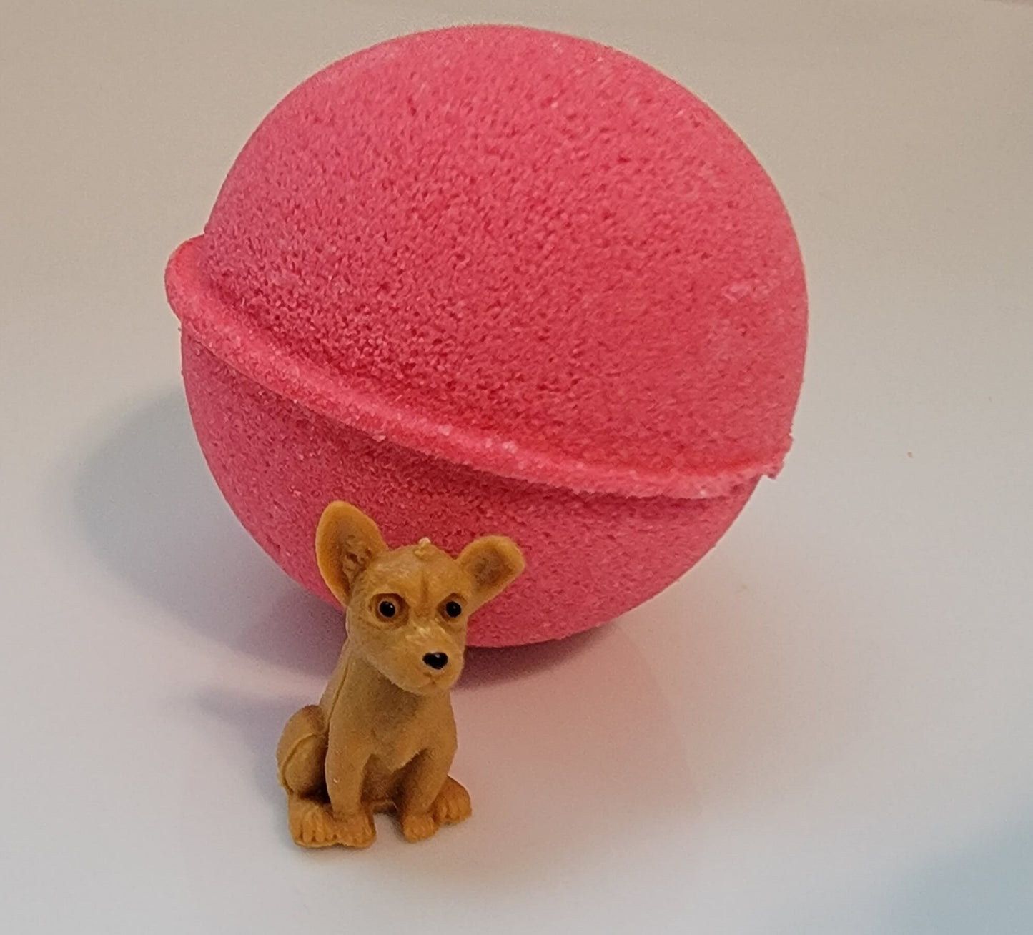 Watermelon scented bath bomb with puppy dog toy inside